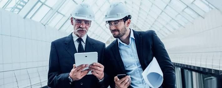 Engineering consultants reviewing a project on a tablet