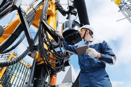 Engineer reviewing derrick schematics on a tablet